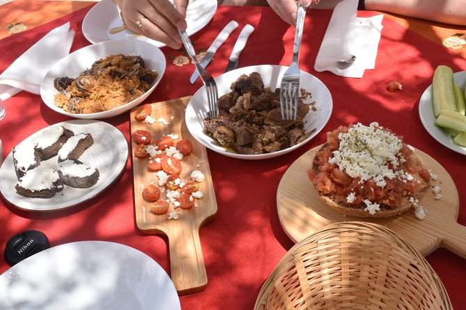 Cretan Farm Tour with Cheese-Making, Olive Oil Tasting & Picnic - Sitting beneath the wooden roof for lunch