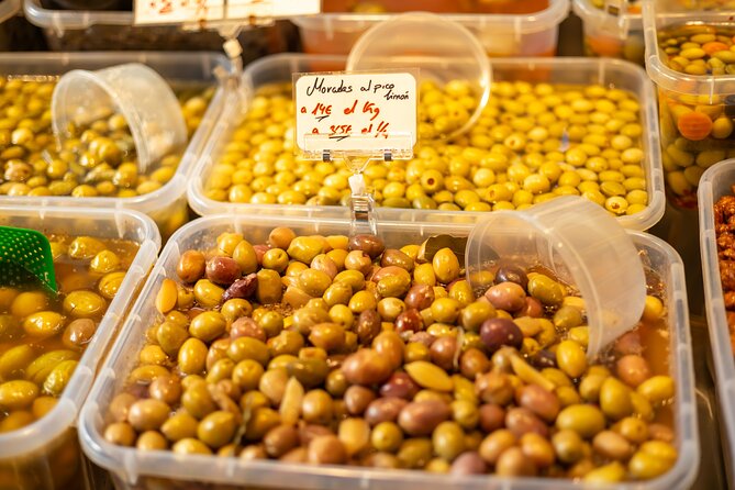 Malaga Food Tour with 12+ Tastings: Tapas, Olive Oil, Ham & More - One hour inside Mercado Central de Atarazanas